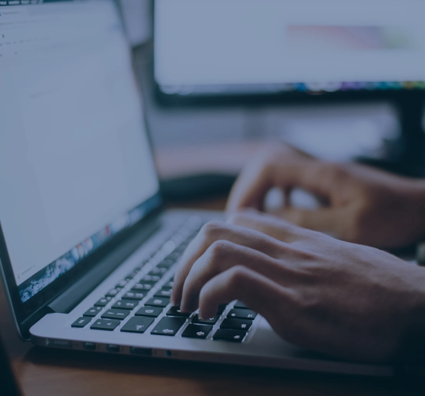 mains écrivant sur un clavier d'ordinateur portable